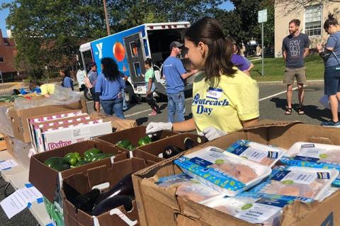 A Tufts student volunteers at a YMCA pop-up food pantry.