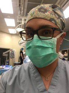 Katie Calicchio in a green surgical mask and scrubs