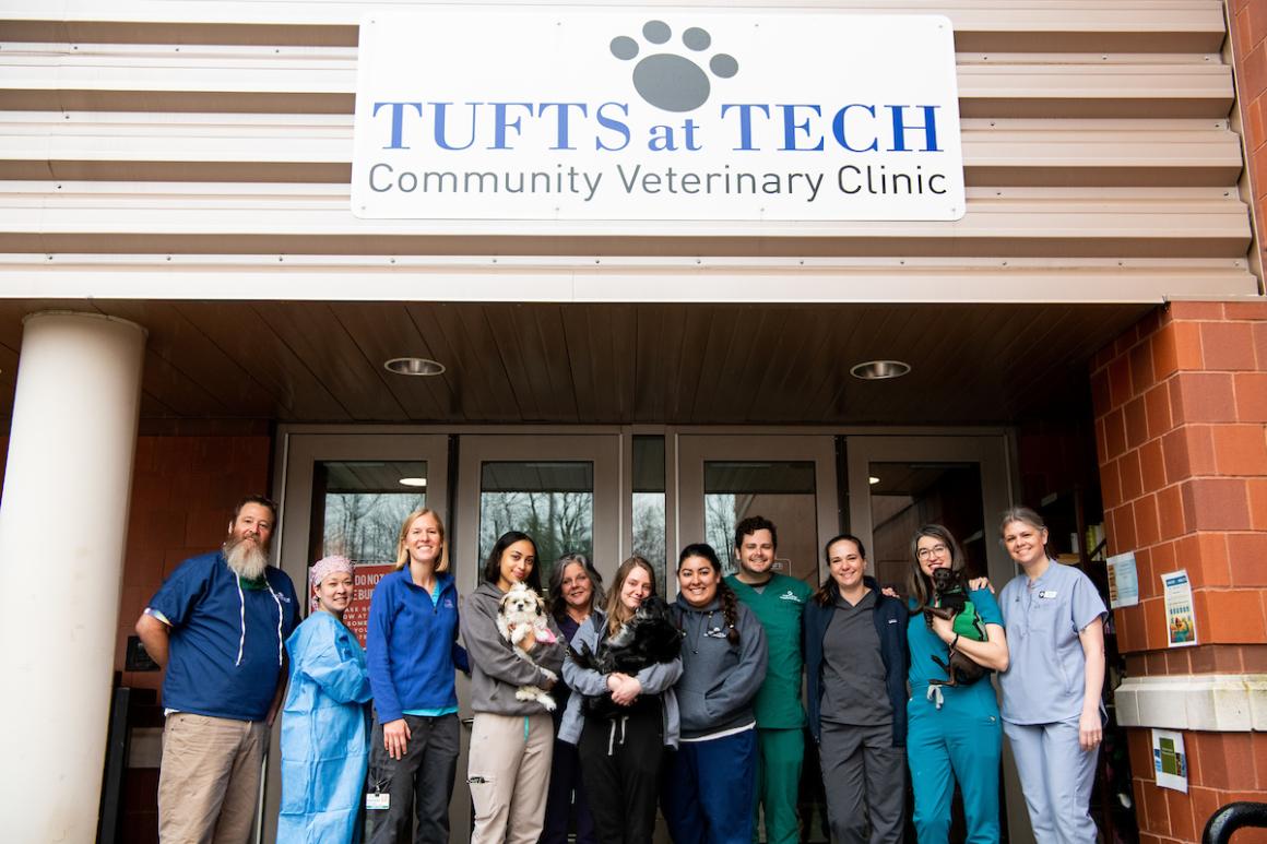 group of veterinarians and vet techs standing on steps outside of Tufts at Tech Community Veterinary Clinic