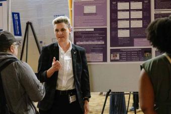student explaining her research at Research Day