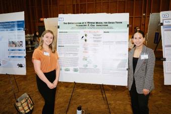 2 young women presenting their post research project