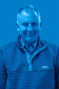 Dominik Faissler smiling. Image has a blue filter.