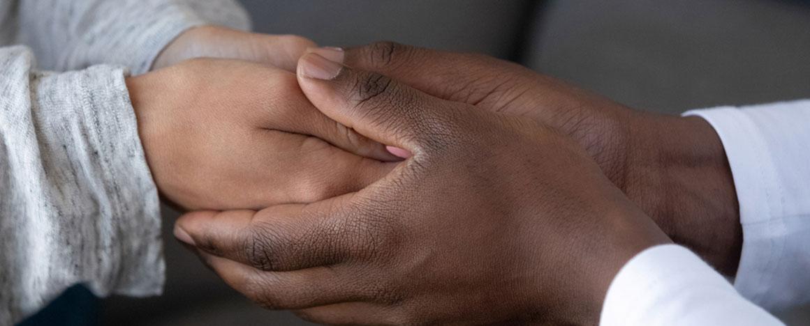 Two people holding hands