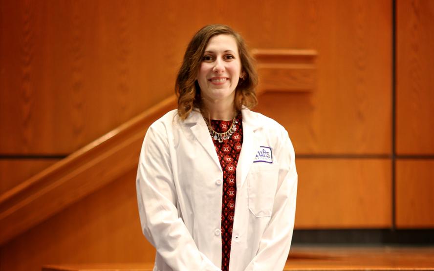 Alexandra Christodoulou standing in her Tufts lab coat