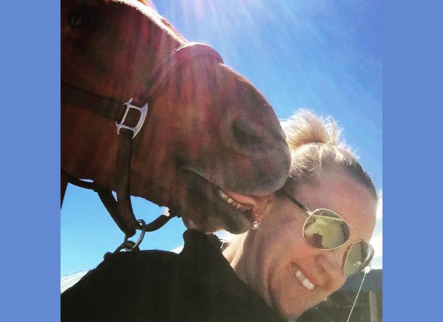 Bridget Hatch being licked by a horse