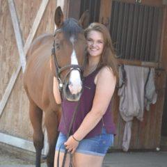 Alumni Shannon Giguere with a horse