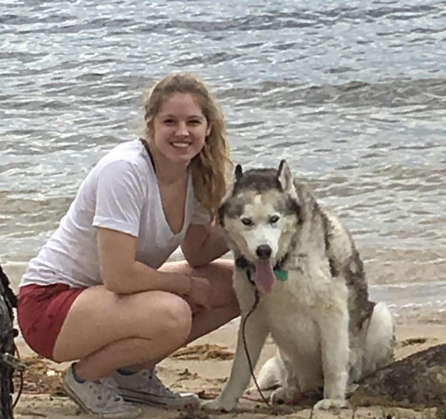 Alumni Alexandria Laing at a beach with a dog