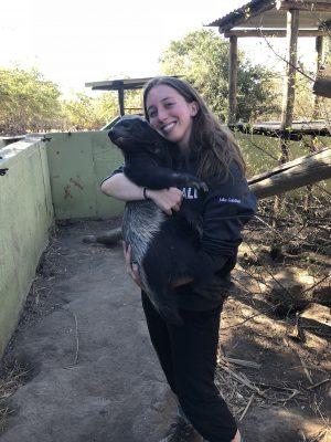 Julia Gardner hugging a honey badger