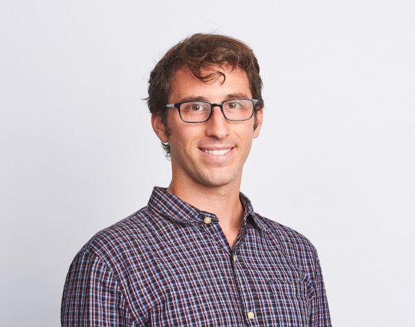 Professional photo of a man with glasses.