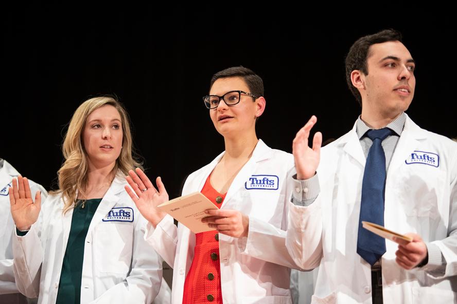 3 veterinary students taking their veterinary oath at the white coat ceremony