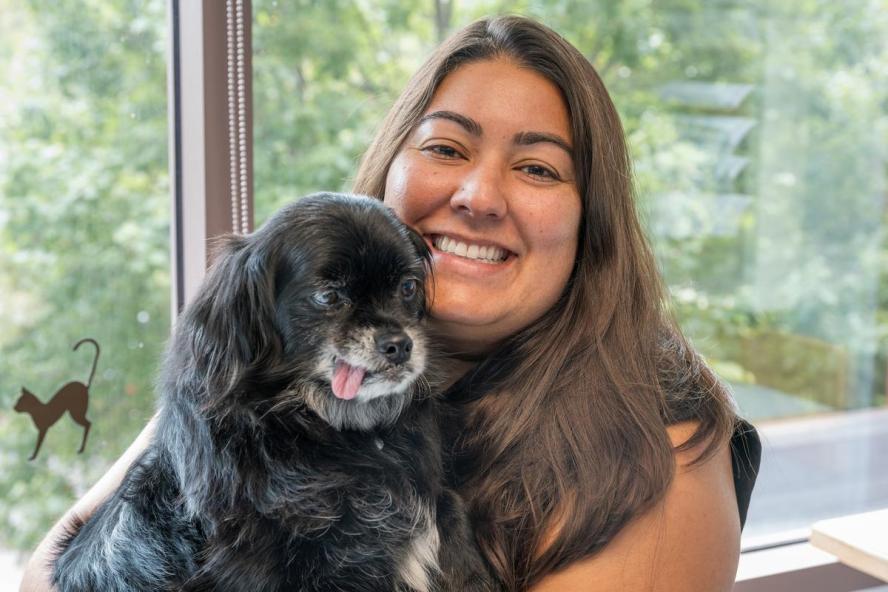 Dr. Kayla Sample holding her dog.