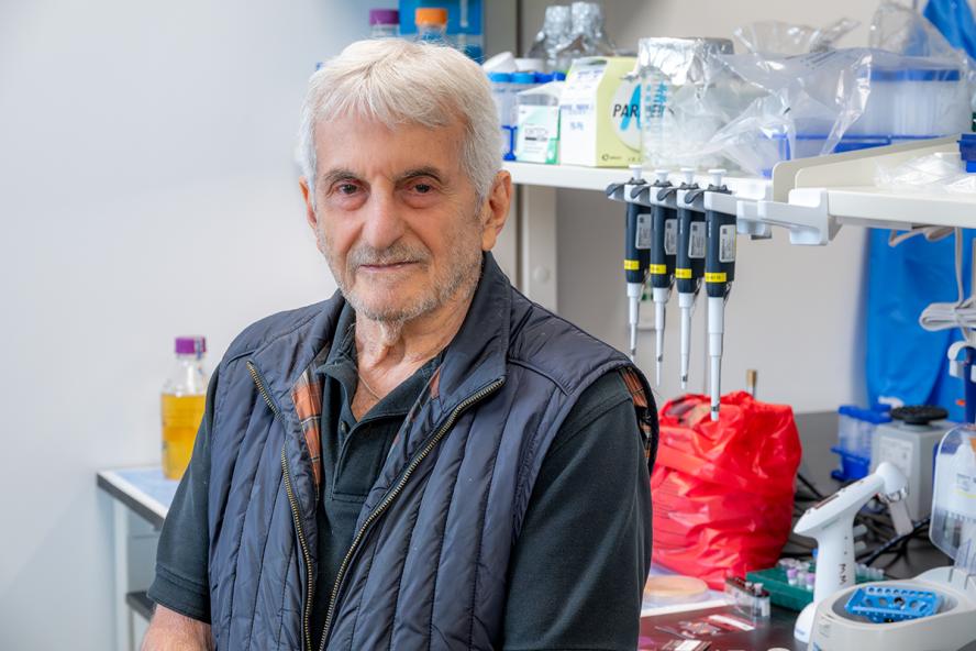 Distinguished Professor and Agnes Varis University Chair Emeritus Saul Tzipori standing in his lab.