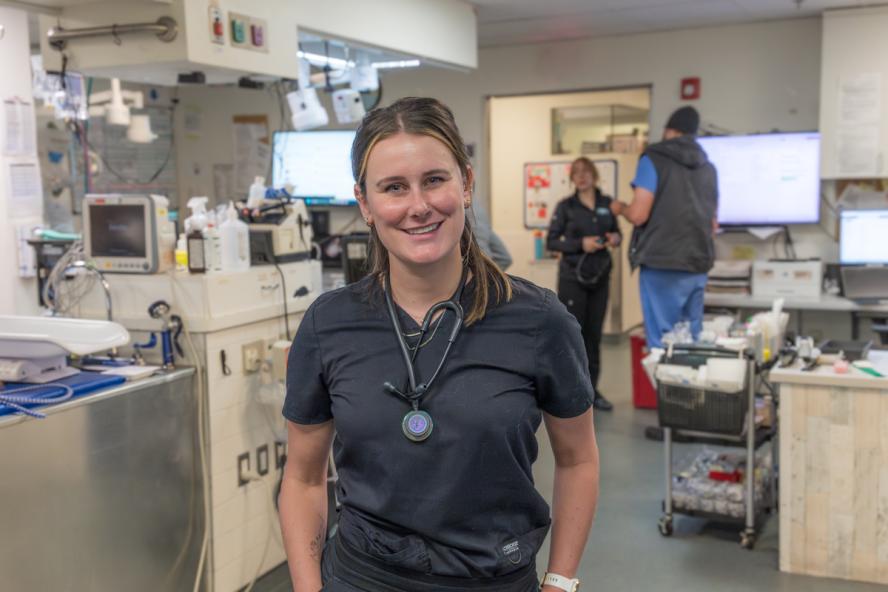 Kelsea Studer wearing scrubs standing in a hospital setting.