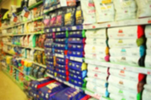 Blurry photo of pet food section at a grocery store.