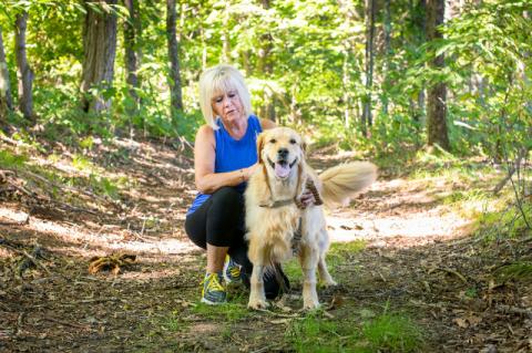 Brooklyn, a three-year-old golden retriever, and Jayne Smith pose for a photo, along one of their usual walking paths.