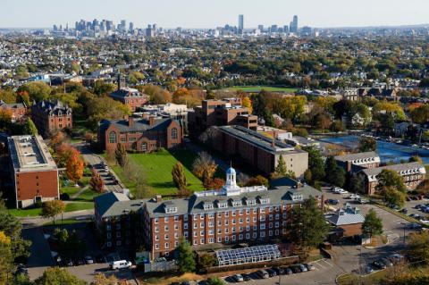Aerial view of the Medford/ Somerville campus, with the Boston skyline in the background.