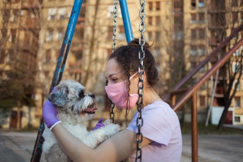Close up of girl playing with her dog on the playground.