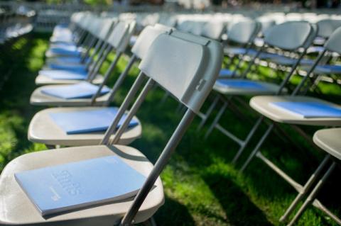 Rows of folding chairs at Tufts commencement.