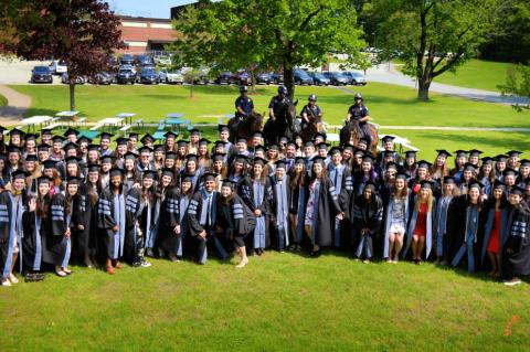 Class of 2019 veterinarian students pose in graduation apparel.