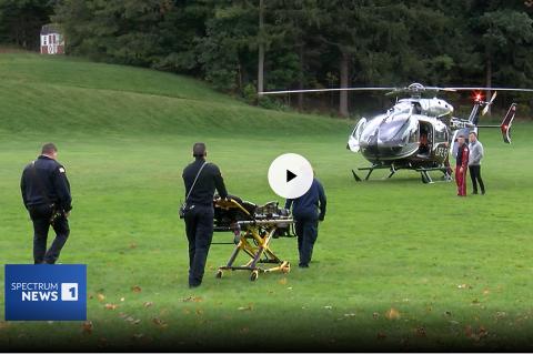 EMTs transporting an injured K-9 off a life flight