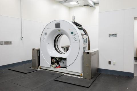 a room with white walls and a new CT scanner being installed.