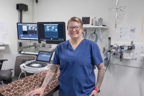 Marie Gryszowka, Veterinary Technician 2, standing next to an ultrasound machine