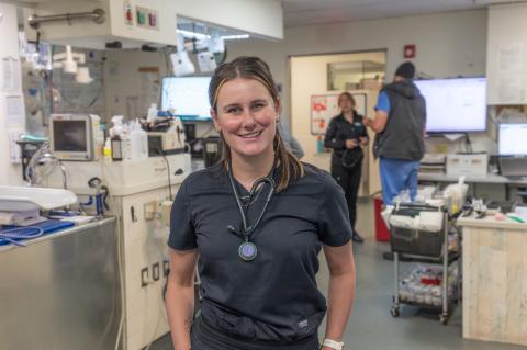 Kelsea Studer wearing scrubs standing in a hospital setting.