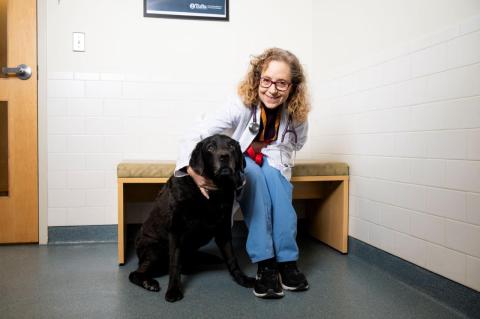 Veterinarian Dr. Cheryl London poses for a photo with Oscar, a handsome black Labrador retriever, during his appointment at the Foster Hospital for Small Animals on Tufts' campus in North Grafton, Massachusetts.